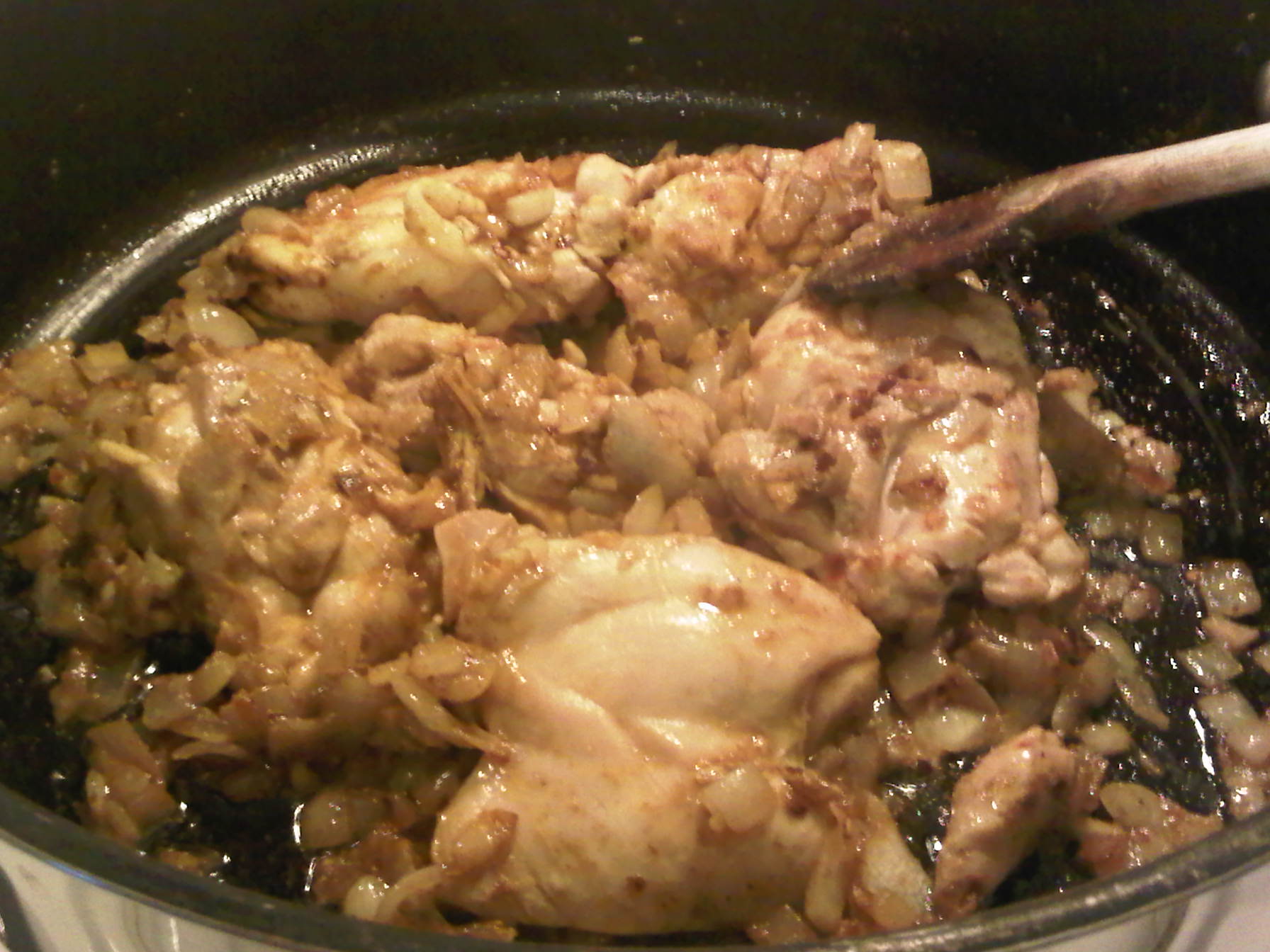 Combining chicken thighs and spices for Chicken Curry