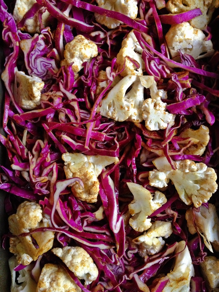 Raw cauliflower and shredded raw cabbage tossed evenly with curry powder, salt and olive oil