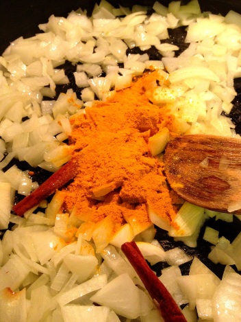 Adding turmeric to onions and whole spices for Lamb Keema
