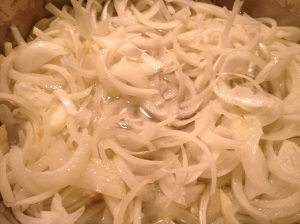Sliced onions in hot oil on stovetop
