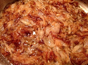 Sauteing sliced onions until they are reddish-brown