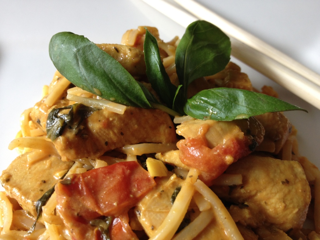 Thai peanut chicken curry with coconut milk, plum tomatoes, and fresh basil