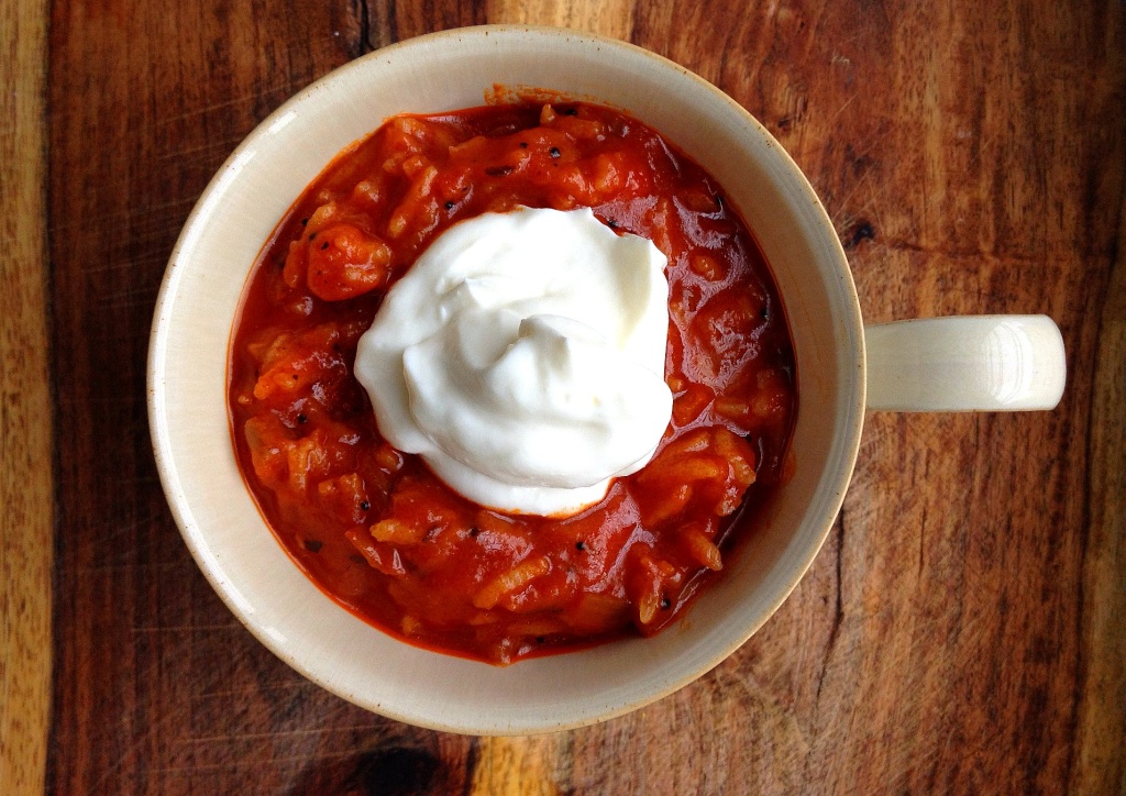 South Indian-style Tomato Rice Soup with dollop of sour cream