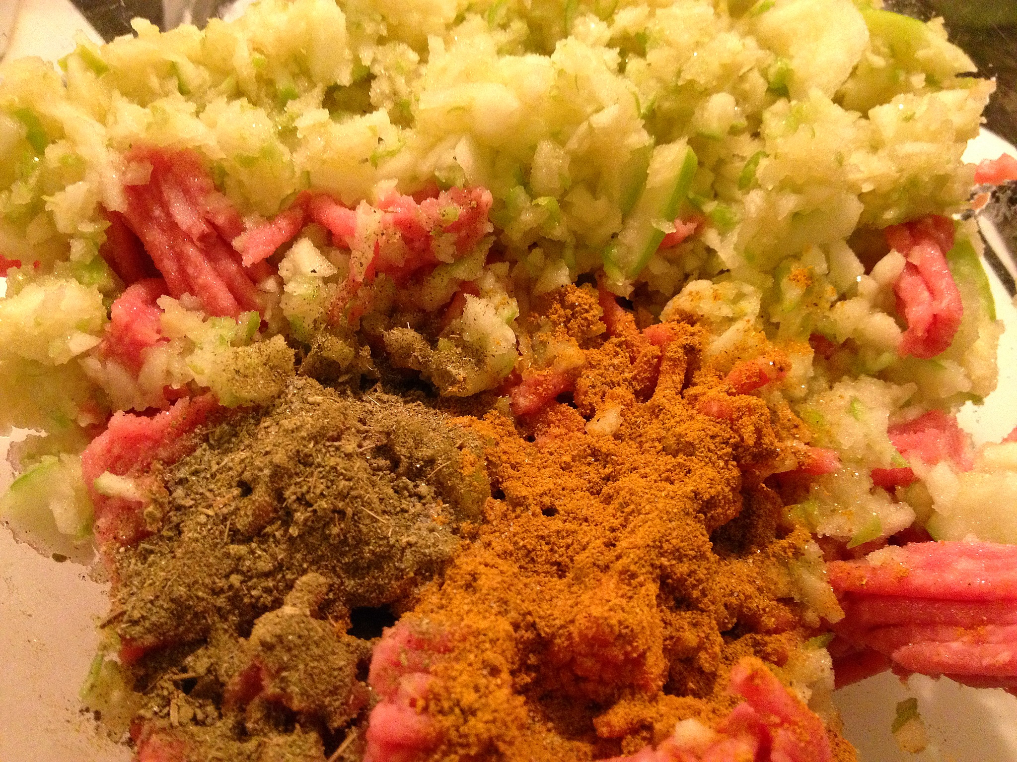 Combining ground turkey, shredded green apple and spices for curried turkey burgers