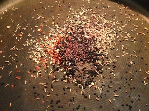 Heating oil and spices for Baingan Burtha (Eggplant Curry)