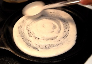 Making dosa on a cast iron pan