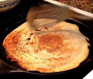 Making dosa on a cast iron pan