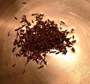 Heating canola oil and cumin seeds for Mattar Paneer