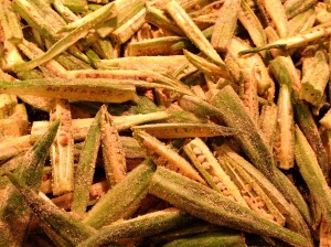 Tossing okra slices gently with spice mixture
