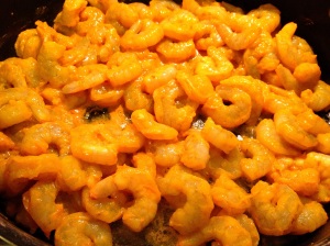 Sauteing turmeric shrimp in non-stick skillet for Indian shrimp curry